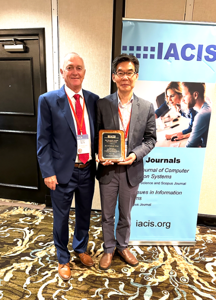 Dr. Myungjae Kwak holds his IACIS 2024 Ben Bauman Award of Excellence at the 2024 International Association for Computer Information Systems (IACIS) Fall Conference in Atlantic Beach, Florida.